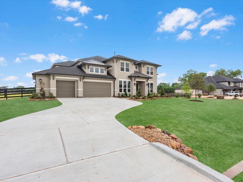 Front exterior of a new home in The Estates at James Lane, Fulshear, TX, highlighting curb appeal (Image 2). Front exterior of a new home in The Estates at James Lane, Fulshear, TX, highlighting curb appeal (Image 2).