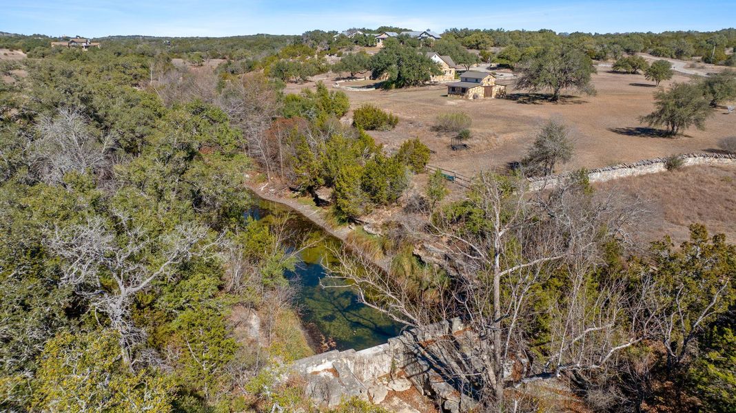 Aerial view of property's location featuring a tree filled landscape