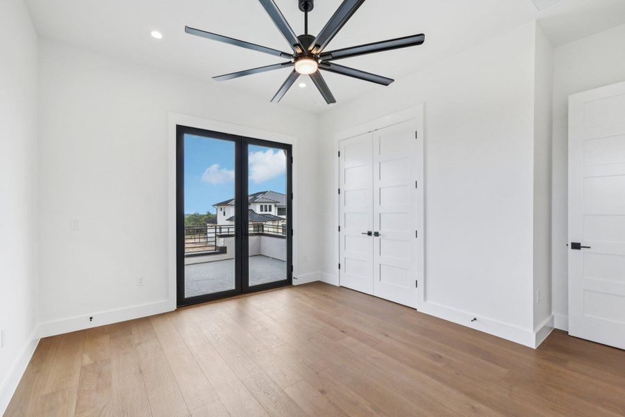 Unfurnished bedroom with access to exterior, light wood-style floors, recessed lighting, a ceiling fan, and a closet