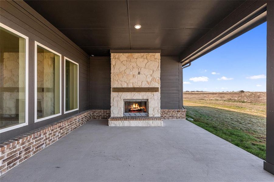 View of patio / terrace with an outdoor stone fireplace