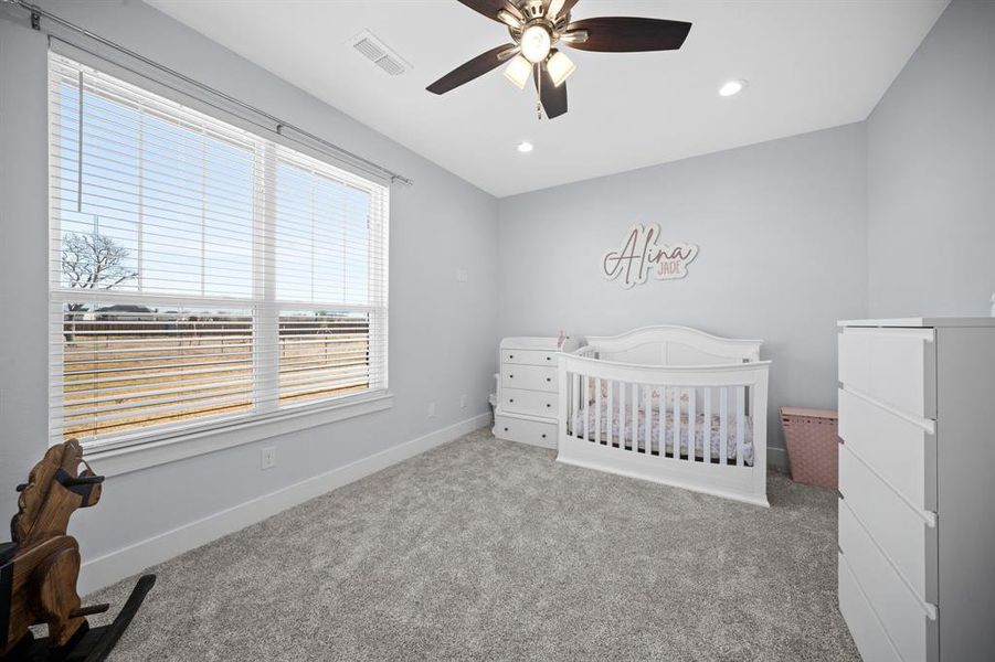 Bedroom with a crib, carpet, ceiling fan, and recessed lighting