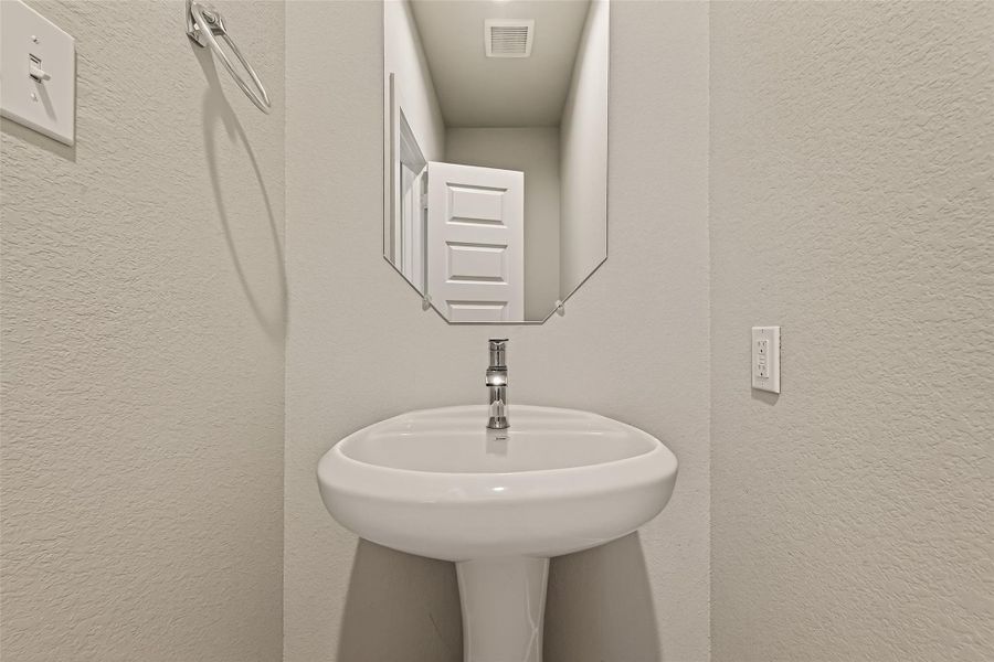 This is the first-floor half bath, designed for convenience and easy access from the main living areas.