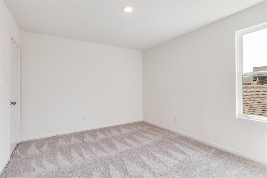 Carpeted spare room featuring baseboards and recessed lighting