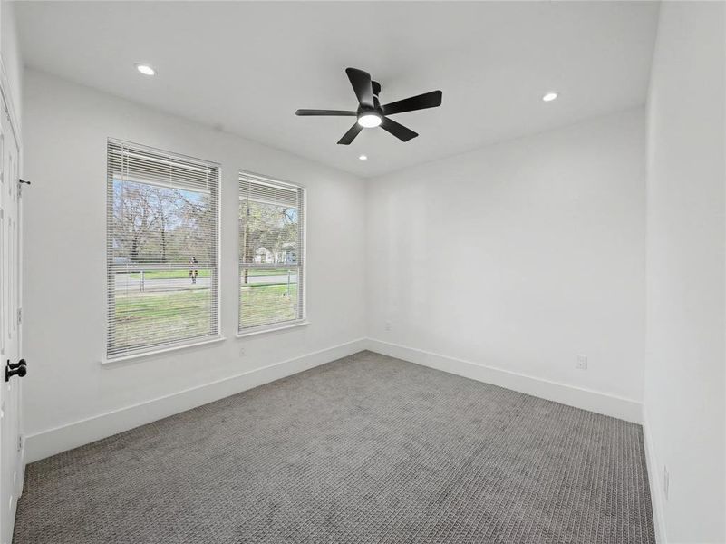 Carpeted spare room featuring a ceiling fan and recessed lighting