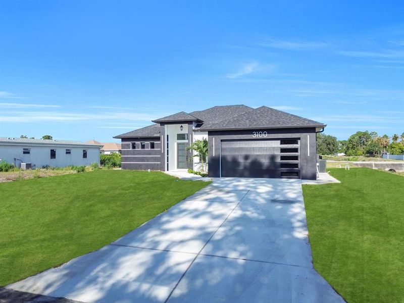 Front exterior of a new home in , Lehigh Acres, FL, highlighting curb appeal (Image 22).