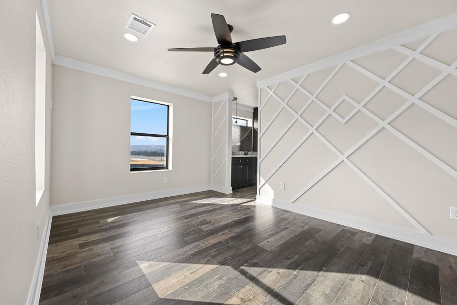 Unfurnished living room featuring dark wood-style floors, ceiling fan, ornamental molding, and recessed lighting Unfurnished living room featuring dark wood-style floors, ceiling fan, ornamental molding, and recessed lighting