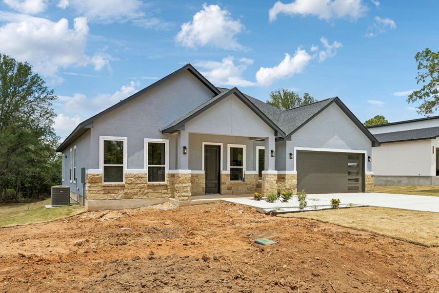 Front exterior of a new home in , Bastrop, TX, highlighting curb appeal (Image 22).
