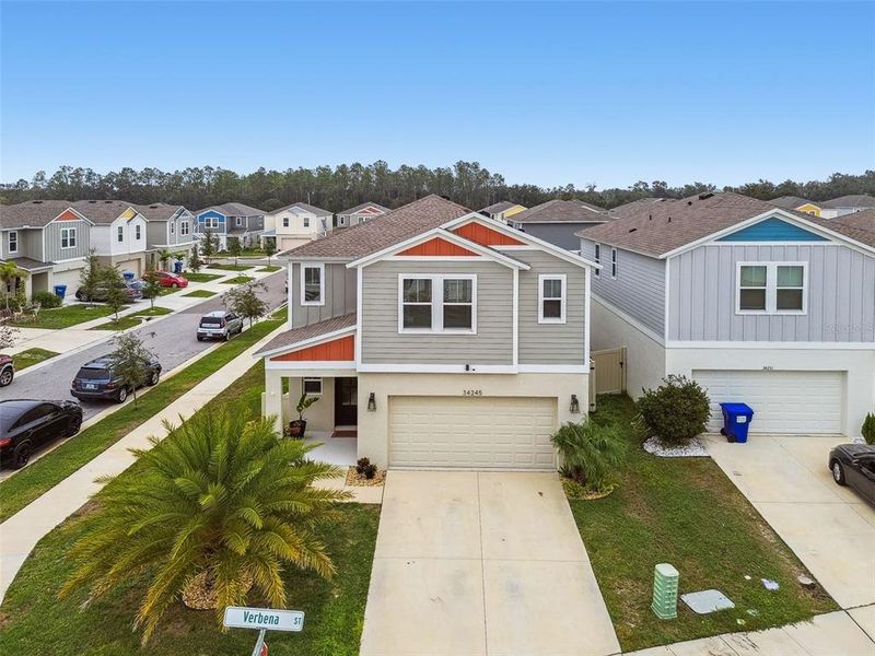 Front exterior of a new home in Pasadena Point, Wesley Chapel, FL, highlighting curb appeal (Image 23).