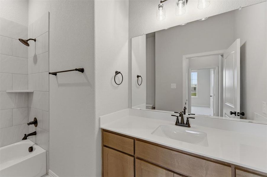 Full bathroom featuring vanity and bathing tub / shower combination