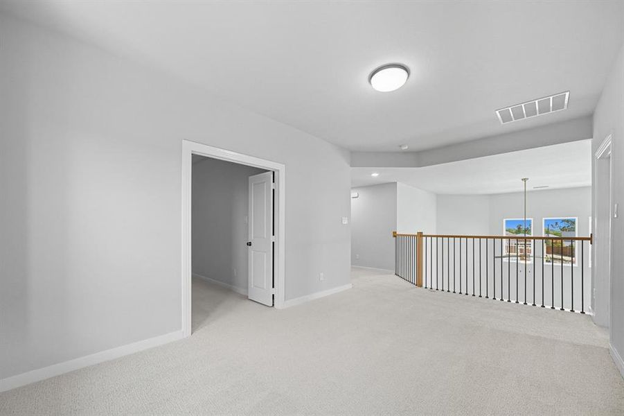Carpeted empty room featuring baseboards and recessed lighting