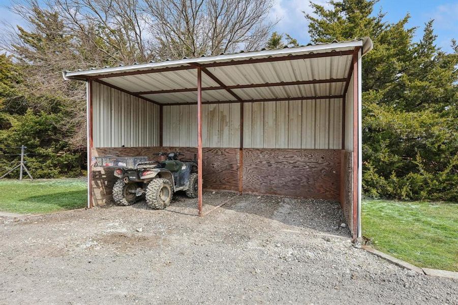 View of outdoor structure with a lawn