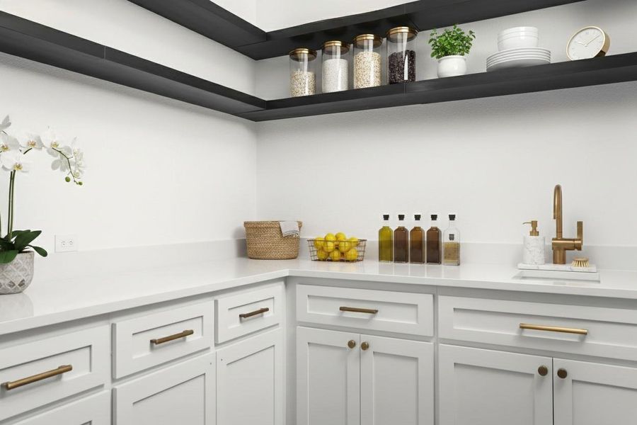 Spacious utility area featuring white cabinetry with gold-toned hardware, light-toned countertops, a gold-toned faucet, and dark open shelving