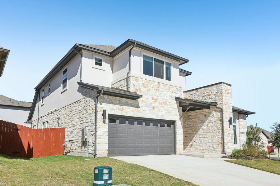 Front exterior of a new home in Sauls Ranch, Round Rock, TX, highlighting curb appeal (Image 2). Front exterior of a new home in Sauls Ranch, Round Rock, TX, highlighting curb appeal (Image 2).
