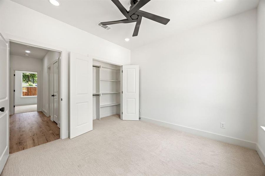 Unfurnished bedroom with carpet flooring, recessed lighting, a closet, baseboards, and a ceiling fan Unfurnished bedroom with carpet flooring, recessed lighting, a closet, baseboards, and a ceiling fan