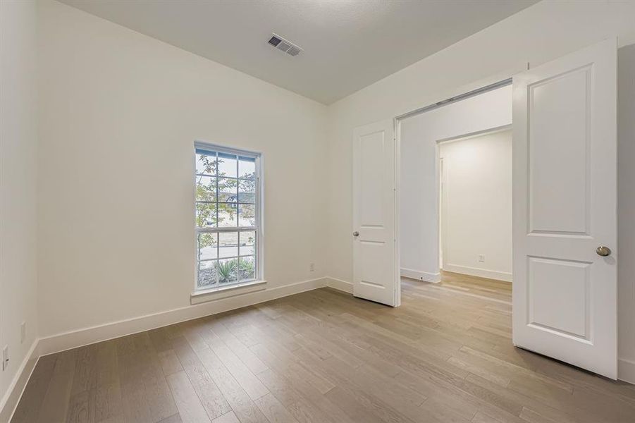 Home office with baseboards and light wood-style floors Home office with baseboards and light wood-style floors