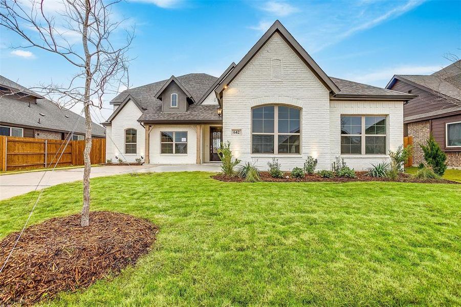 French country style house with a front yard