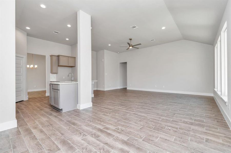 Take another glimpse into the heart of the home with this additional view of the family room—a sprawling space ready to accommodate all your gatherings. Sample photo of completed home. Actual colors and selections may vary.