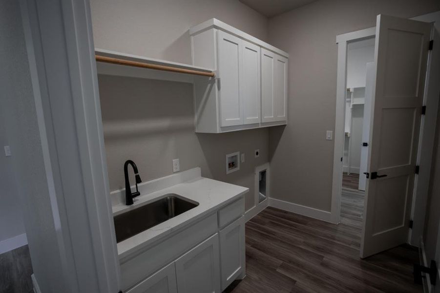 Laundry area with electric dryer hookup, dark wood-style floors, cabinet space, and hookup for a washing machine Laundry area with electric dryer hookup, dark wood-style floors, cabinet space, and hookup for a washing machine