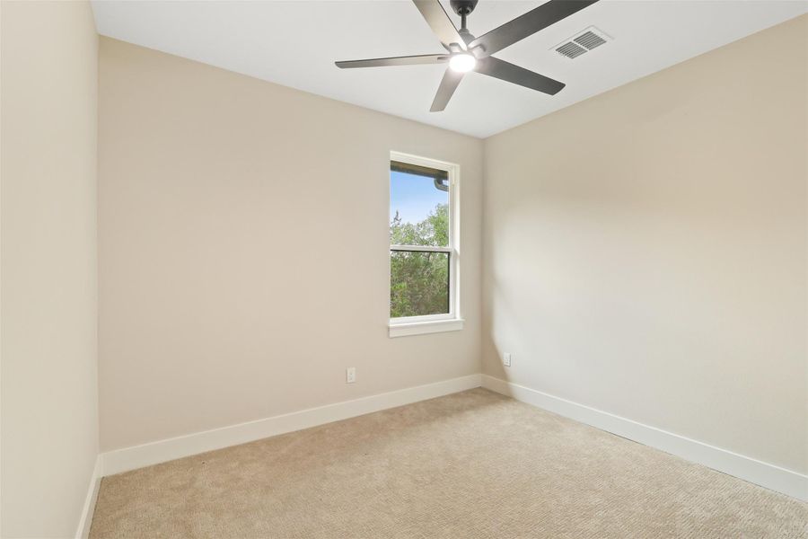 Spare room with visible vents, light colored carpet, and baseboards Spare room with visible vents, light colored carpet, and baseboards