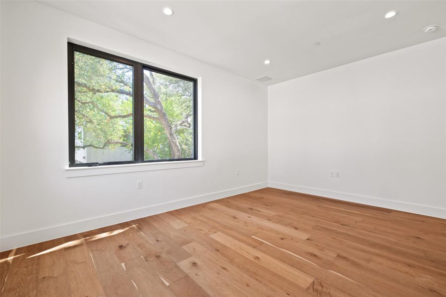Spare room featuring light wood-type flooring and recessed lighting