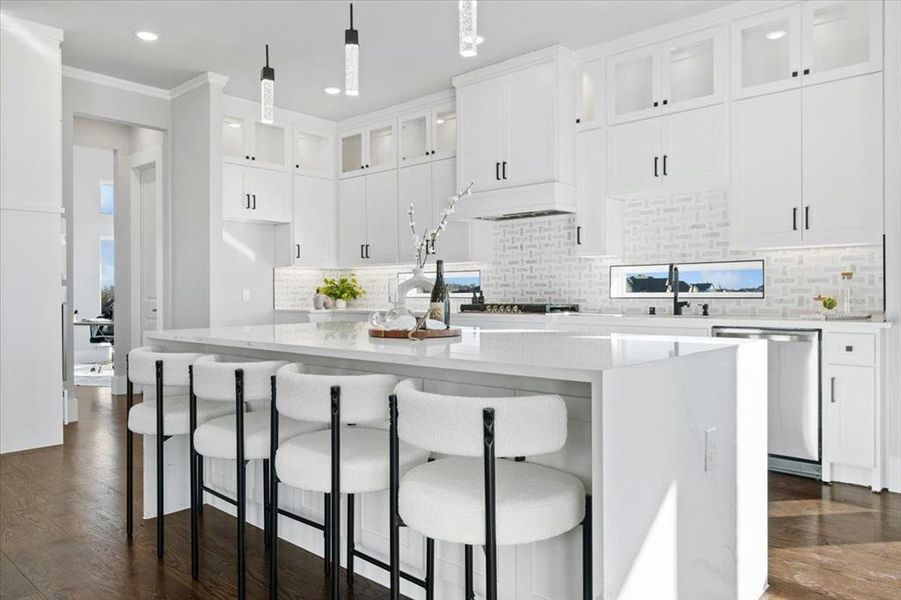 Kitchen with a center island, stainless steel dishwasher, white cabinets, and decorative light fixtures