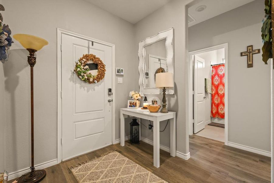 Foyer featuring wood finished floors and baseboards Foyer featuring wood finished floors and baseboards