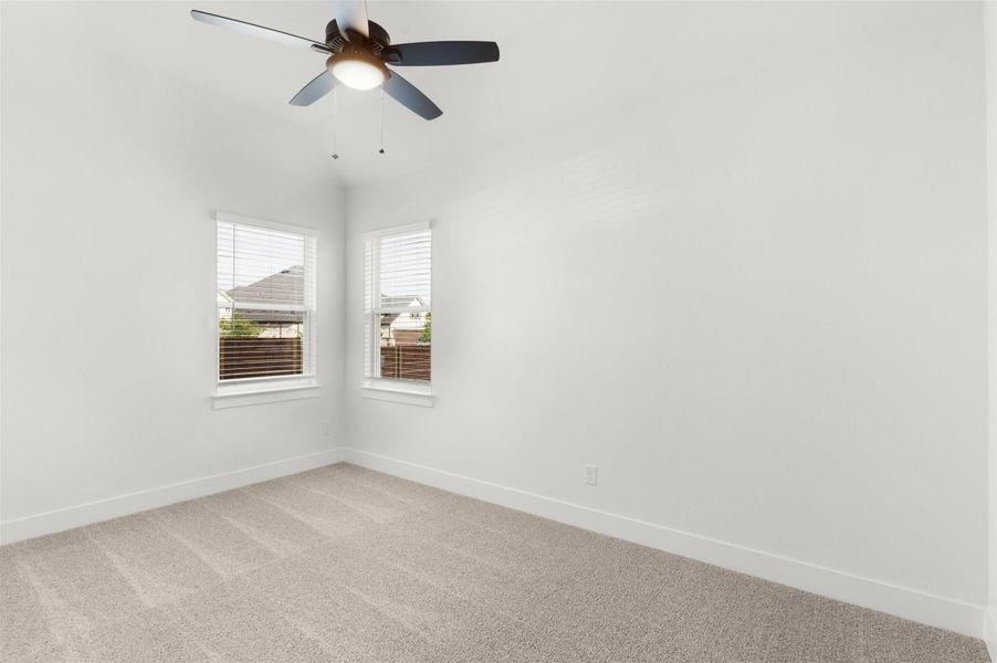 Unfurnished room with carpet flooring, ceiling fan, and vaulted ceiling