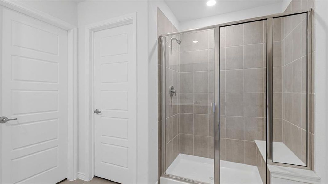 Full bath with a shower stall and recessed lighting