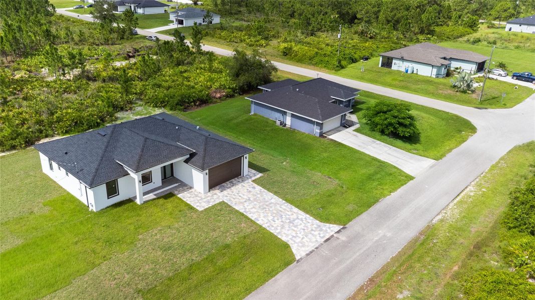 Front exterior of a new home in , Lehigh Acres, FL, highlighting curb appeal (Image 26).