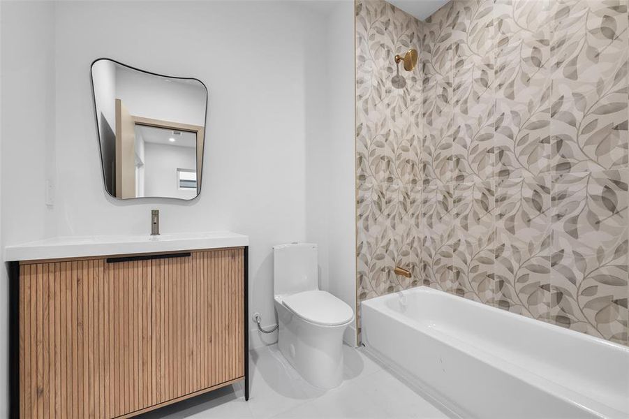 Bathroom featuring vanity, bathing tub / shower combination, and tile patterned floors