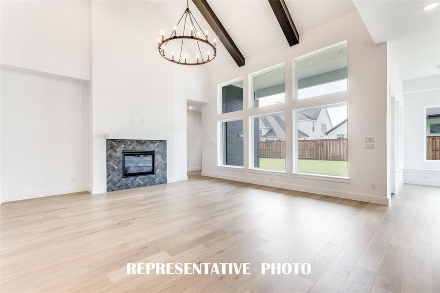 With a wall of windows across the back, this home is flooded with natural light!  REPRESENTATIVE PHOTO