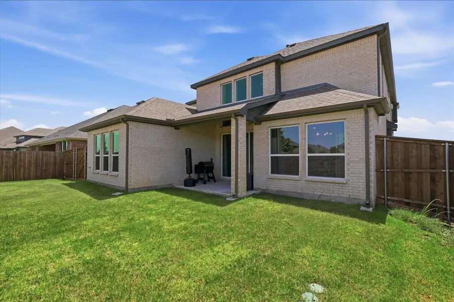 Exterior details and patio area of a home in Valencia on The Lake, Little Elm (Image 21).