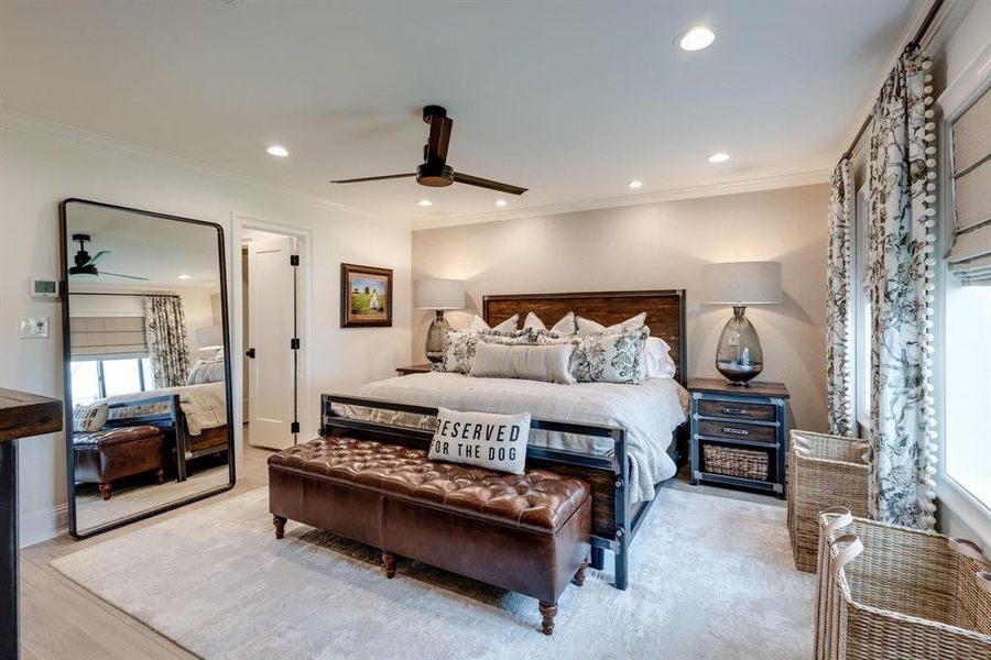 Bedroom featuring ceiling fan, light wood-type flooring, and ornamental molding