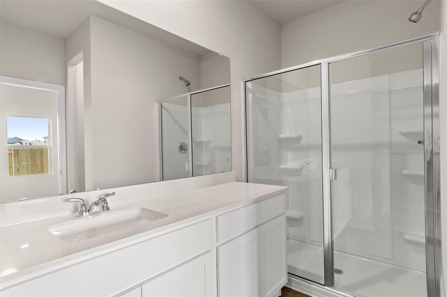 Bathroom with a stall shower and vanity