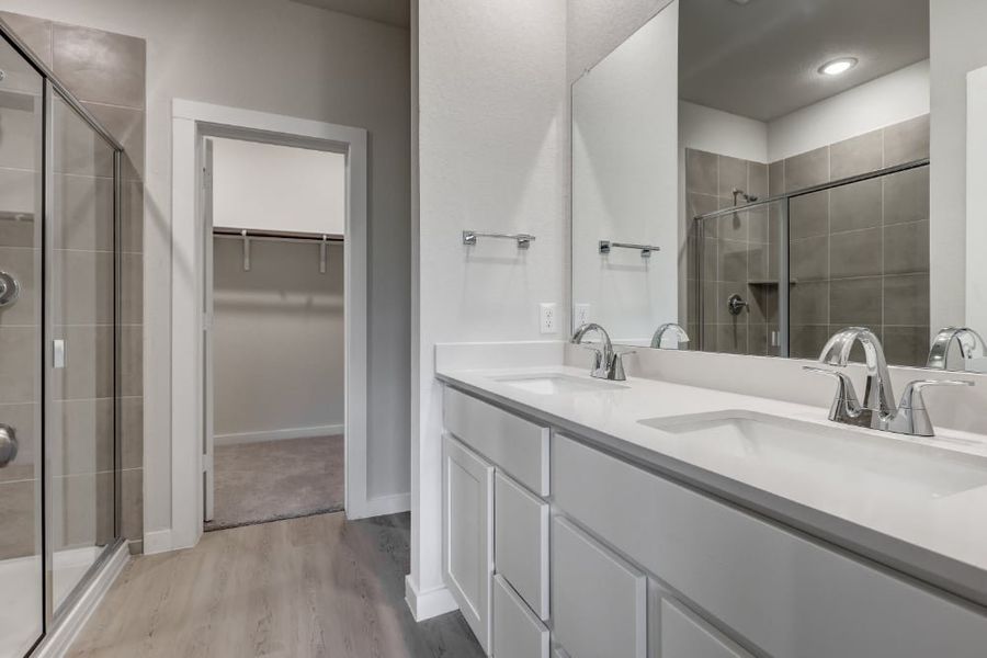 A bathroom with a glass shower. A bathroom with a glass shower.