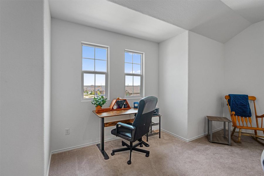Carpeted office space featuring baseboards