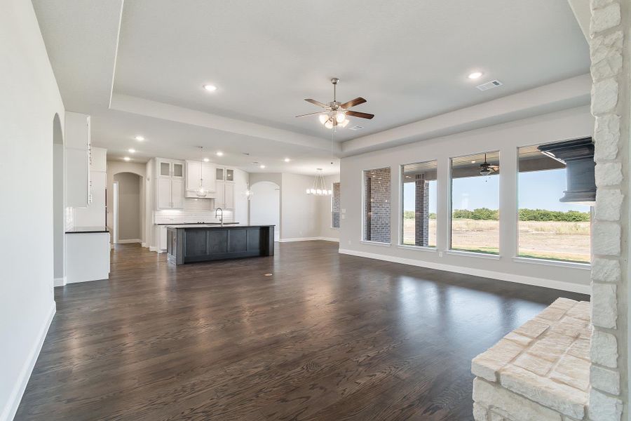 Family Room & Kitchen | Concept 3634 at Hidden Creek Estates in Van Alstyne, TX by Landsea Homes