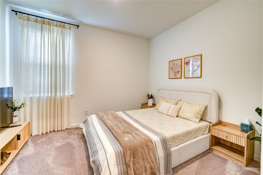 Secondary bedroom boasts a spacious layout with high ceilings and a soothing neutral palette. Expansive windowpanel allows abundant natural light to stream in.