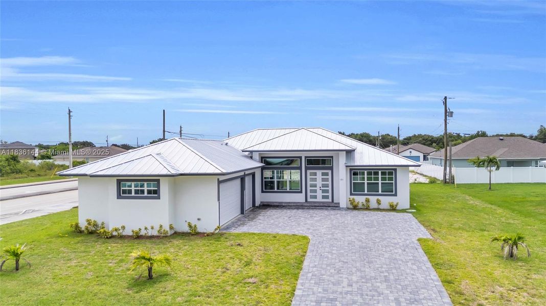 Front exterior of a new home in , Port St. Lucie, FL, highlighting curb appeal (Image 26).