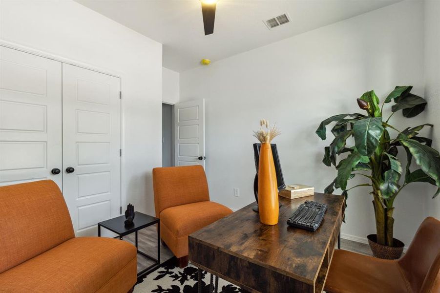 Office with hardwood / wood-style floors and ceiling fan