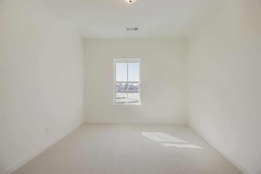 Carpeted spare room featuring baseboards Carpeted spare room featuring baseboards