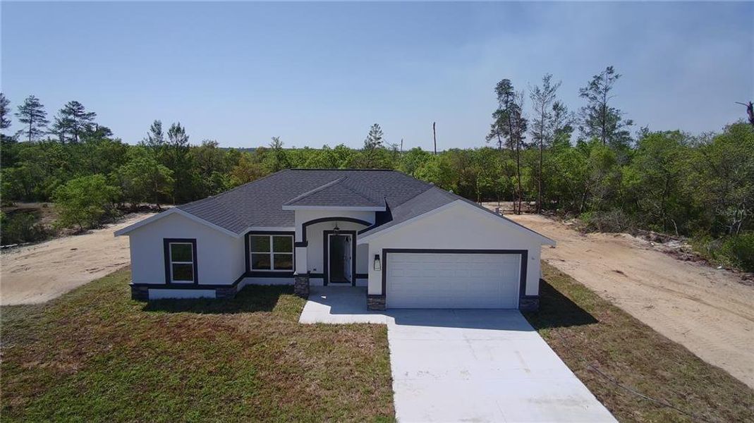Front exterior of a new home in , Dunnellon, FL, highlighting curb appeal (Image 1). Front exterior of a new home in , Dunnellon, FL, highlighting curb appeal (Image 1).