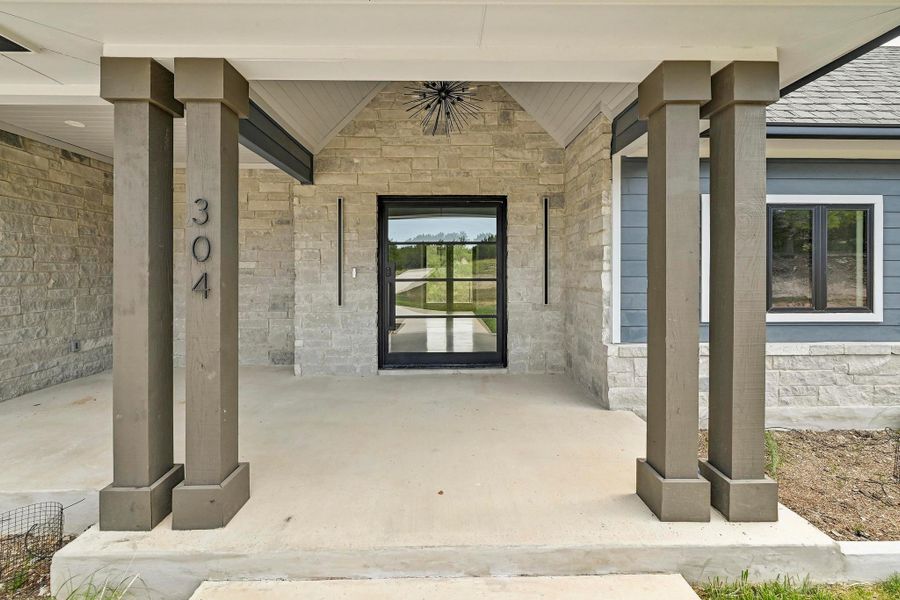 A striking pillared front porch welcomes you home. A striking pillared front porch welcomes you home.