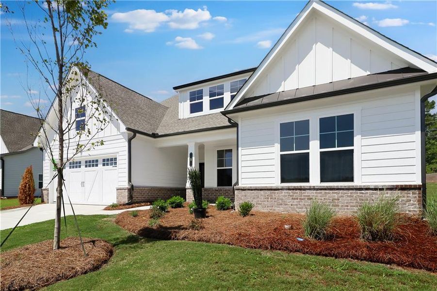 Front exterior of a new home in Twelve Parks 55+, Sharpsburg, GA, highlighting curb appeal (Image 1). Front exterior of a new home in Twelve Parks 55+, Sharpsburg, GA, highlighting curb appeal (Image 1).