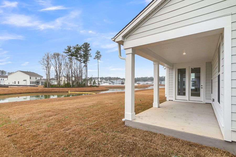 Exterior details and patio area of a home in Tidewater at Lakes of Cane Bay, Summerville (Image 23).