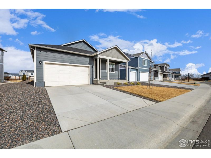 Front exterior of a new home in Fossil Creek Ranch, Windsor, CO, highlighting curb appeal (Image 1). Front exterior of a new home in Fossil Creek Ranch, Windsor, CO, highlighting curb appeal (Image 1).