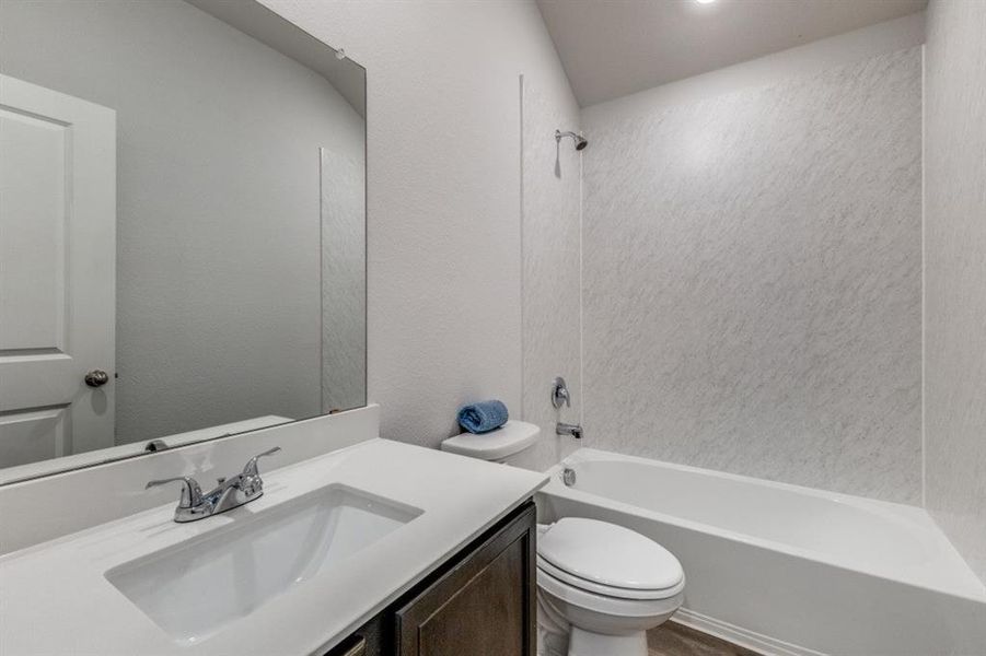 Full bathroom featuring bathing tub / shower combination and vanity Full bathroom featuring bathing tub / shower combination and vanity