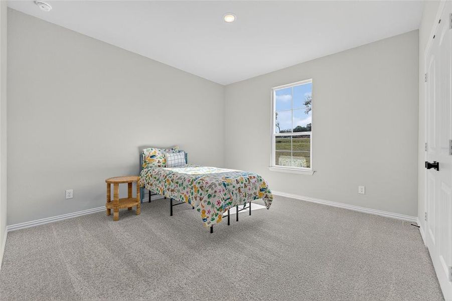 Bedroom featuring light colored carpet and recessed lighting Bedroom featuring light colored carpet and recessed lighting