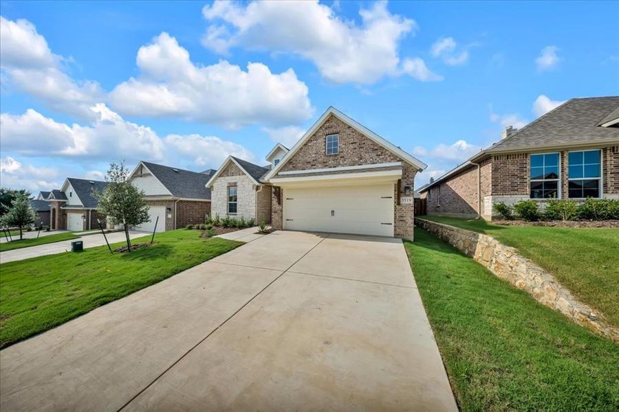 Front exterior of a new home in Liberty Pointe, Gainesville, TX, highlighting curb appeal (Image 21).