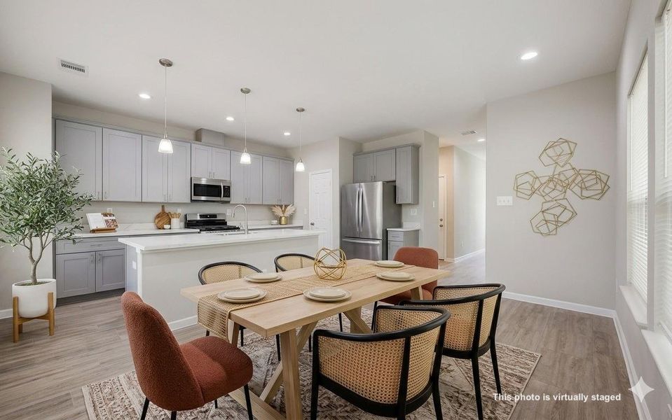Natural light floods this bright dining area, featuring dual windows that create an airy and inviting space for entertaining.
